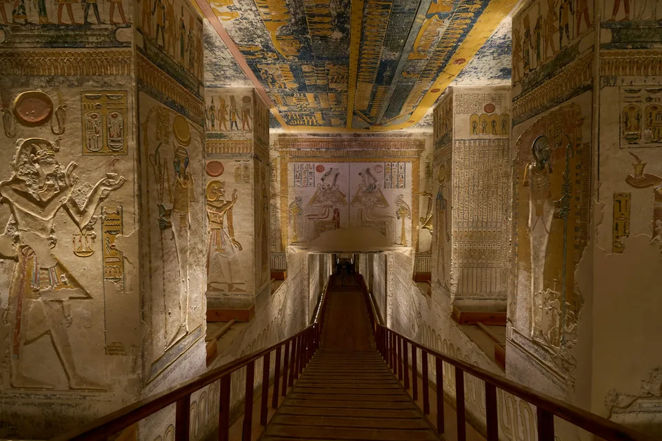 A passage lined with painted ancient Egyptian reliefs