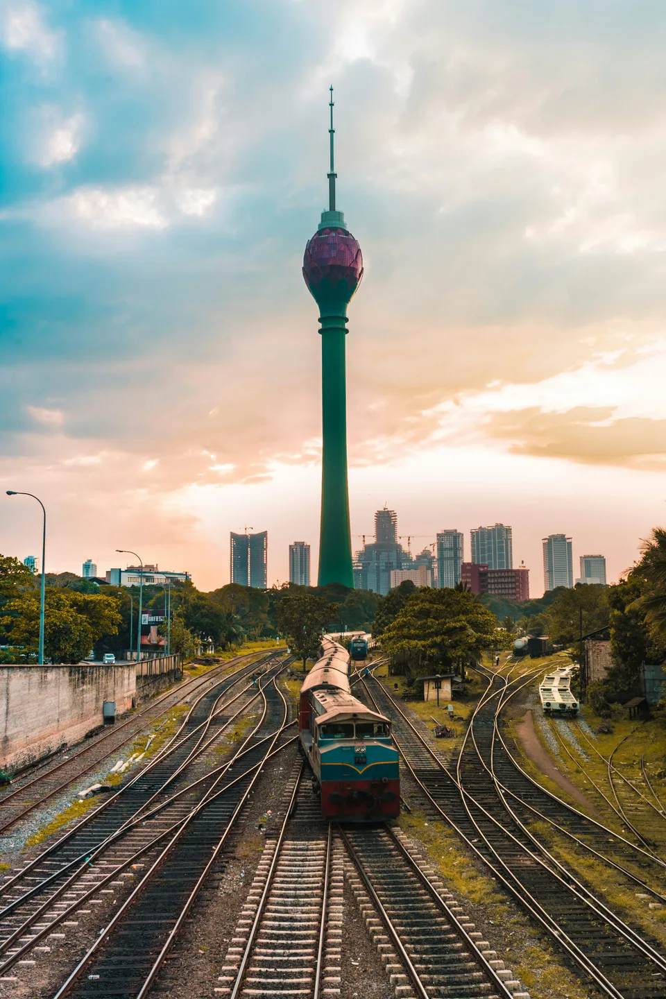 Railway tracks leading towards the Lotus Tower in Colombo at sunset