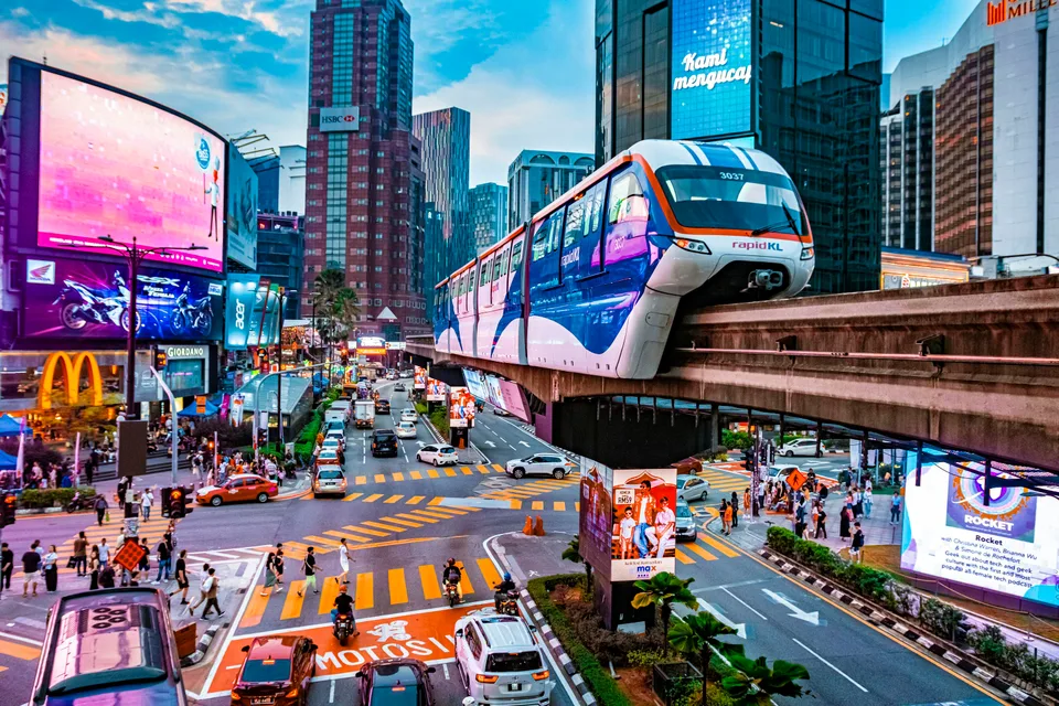 Monorail passing over a busy shopping street in Kuala Lumpur