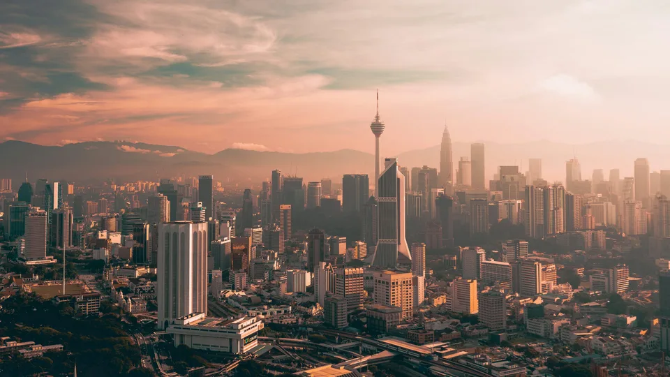 Kuala Lumpur skyline stretching towards the horizon in warm evening light