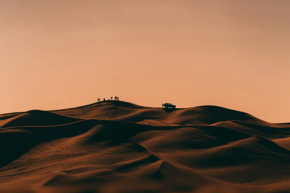 Warm evening light on curved sand dunes