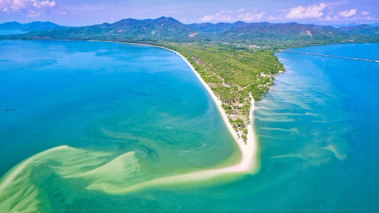 Aerial view of a white sand spit curling into turquoise water off Ko Yao Yai