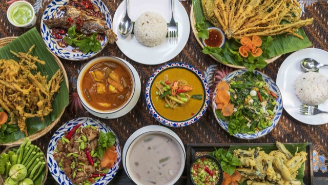 A table of southern Thai dishes with curries, salads and fried seafood